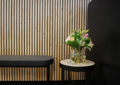 Wooden wall covering with black painted slats. Product: NORTO Bech