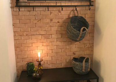 Hallway with a wooden wall decoration and shelves