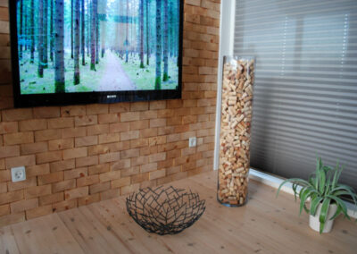 Living room with a wall of untreated solid wood blocks.